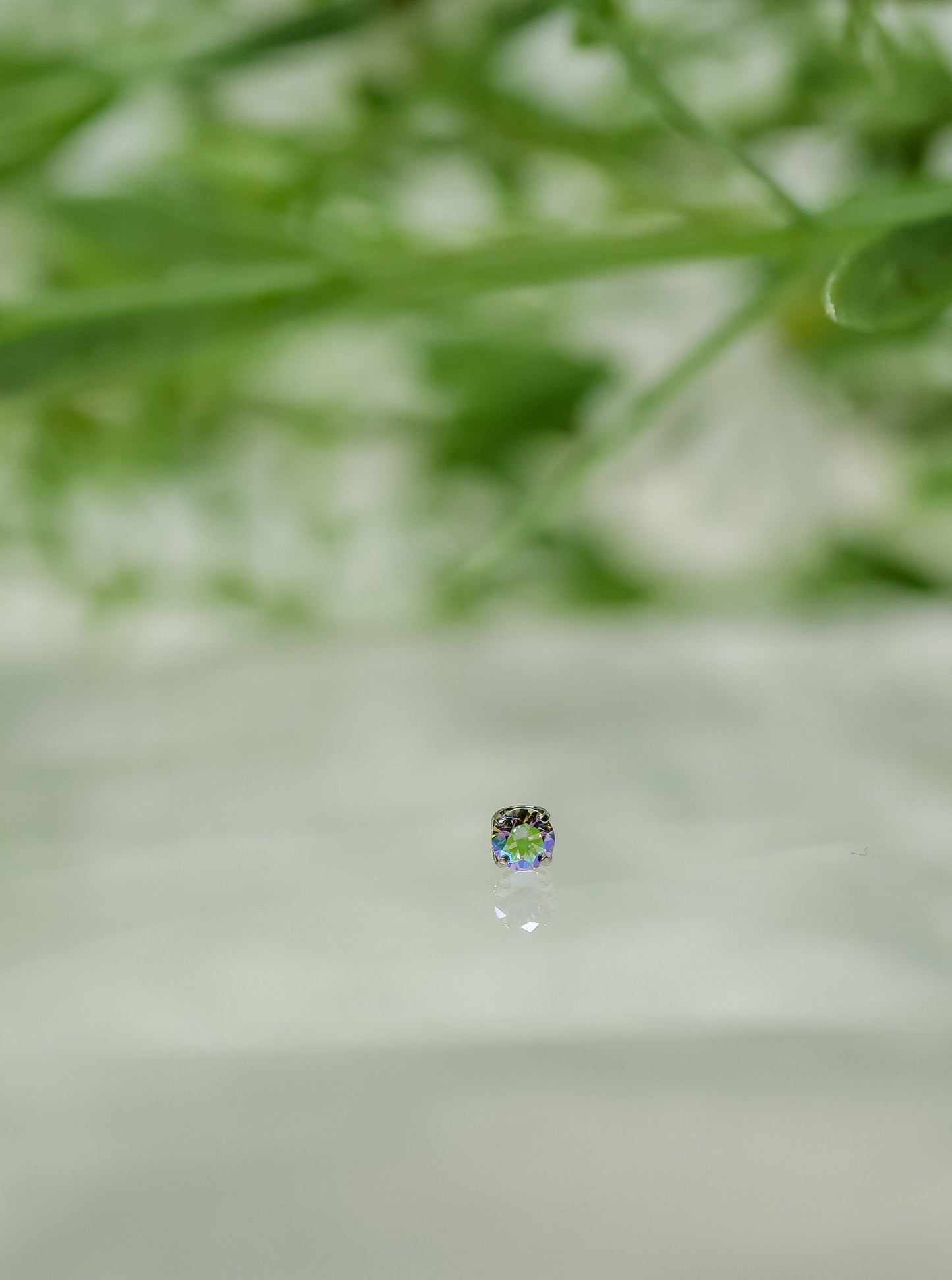 Small Rainbow coloured stone with purples, pinks, green and blue